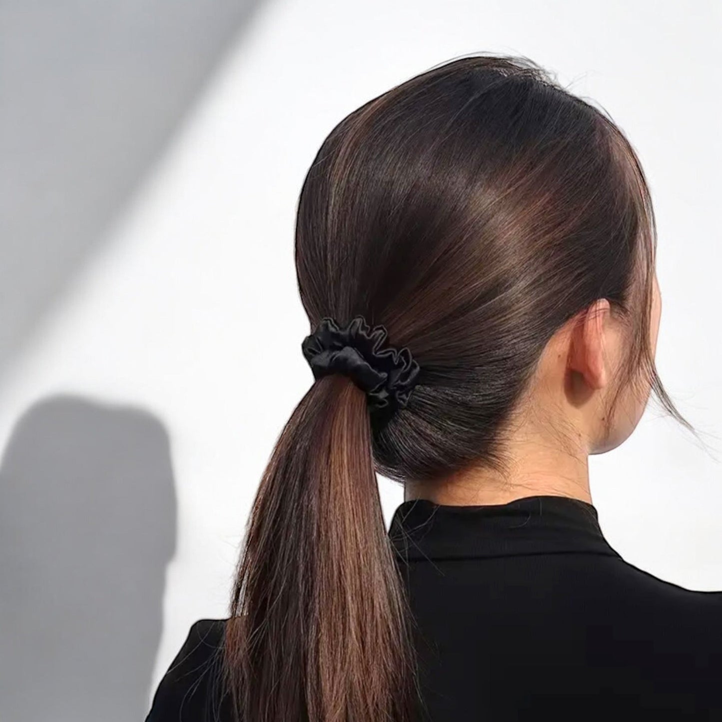 model wearing dimo silk scrunchie in black, ponytail