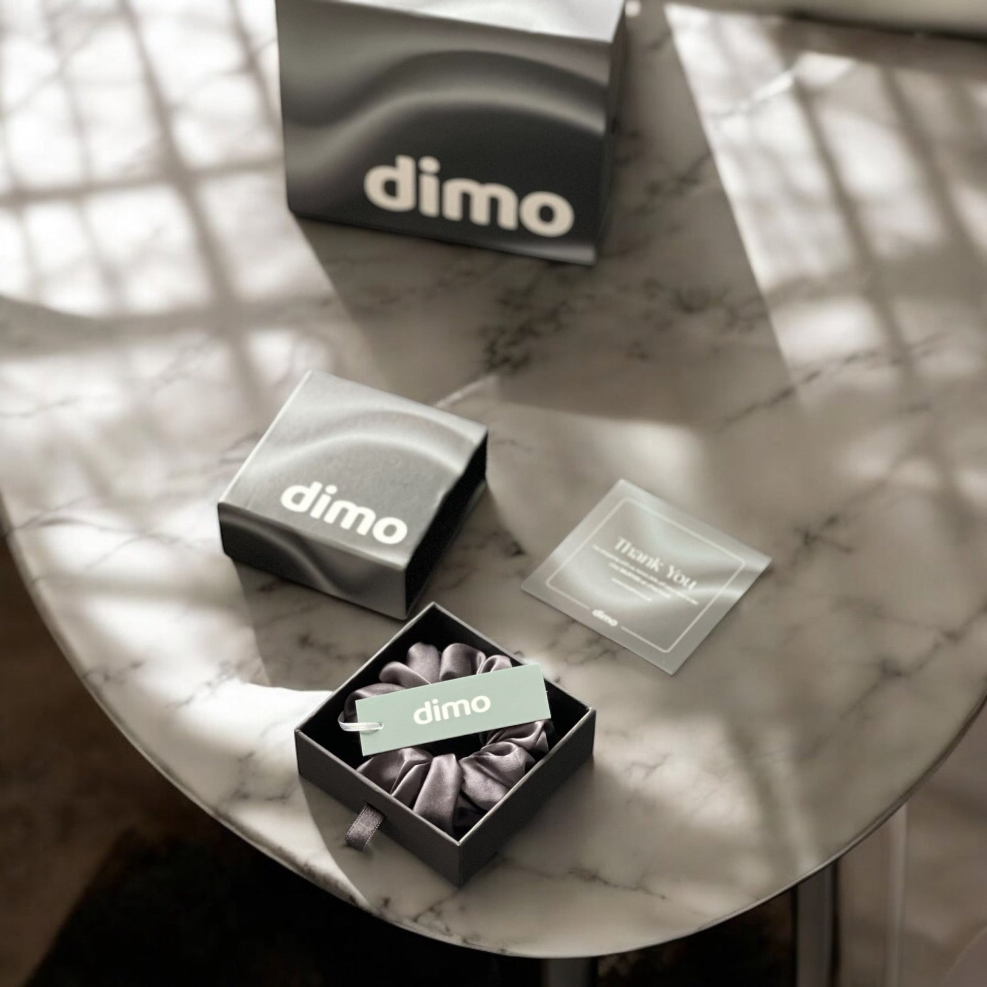 dimo silk brand packaging with silk scrunchie, elegant gift box