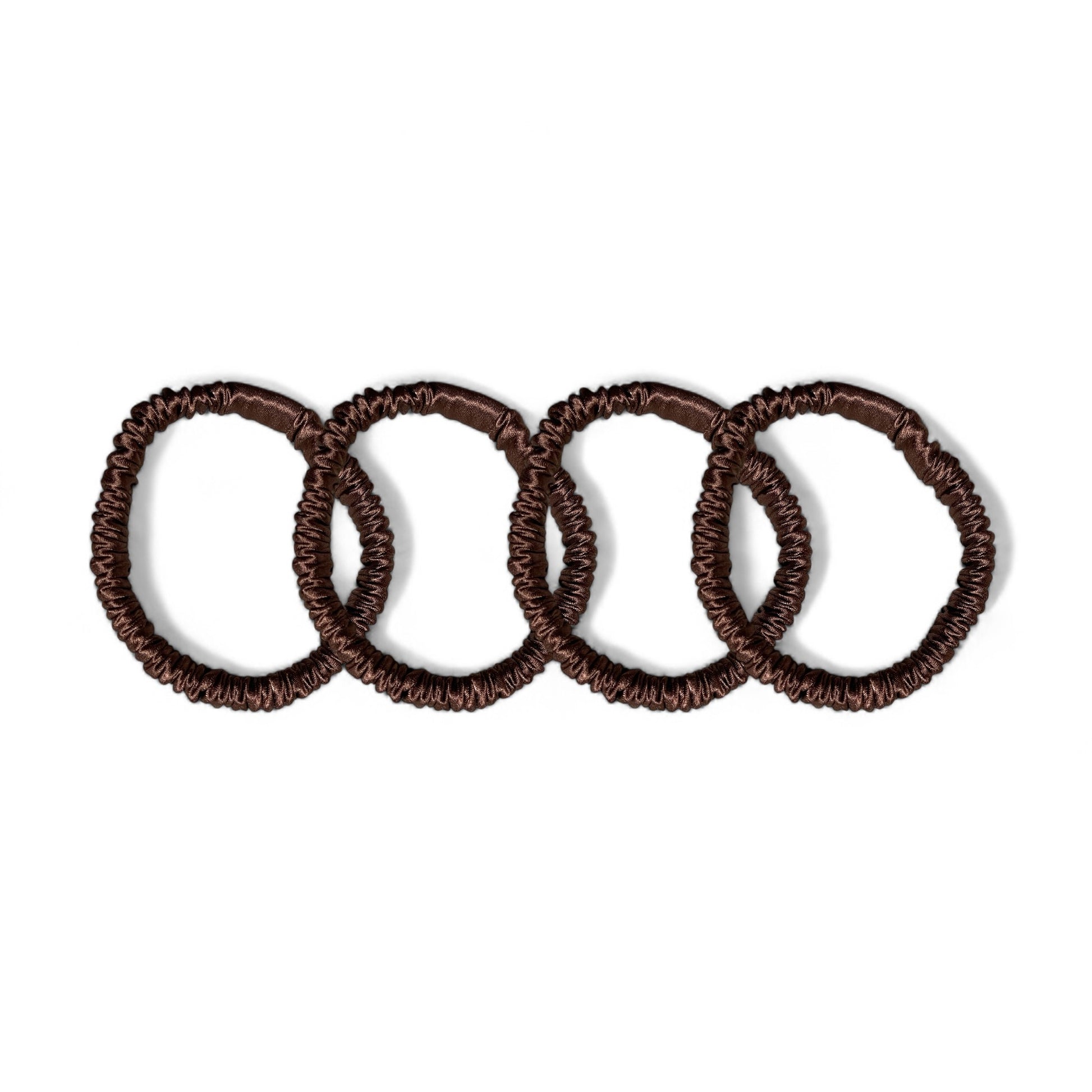 Set of 4 brown mulberry silk skinny hair ties, designed to prevent hair breakage and frizz, offering a sleek and stylish way to keep your hair in place.