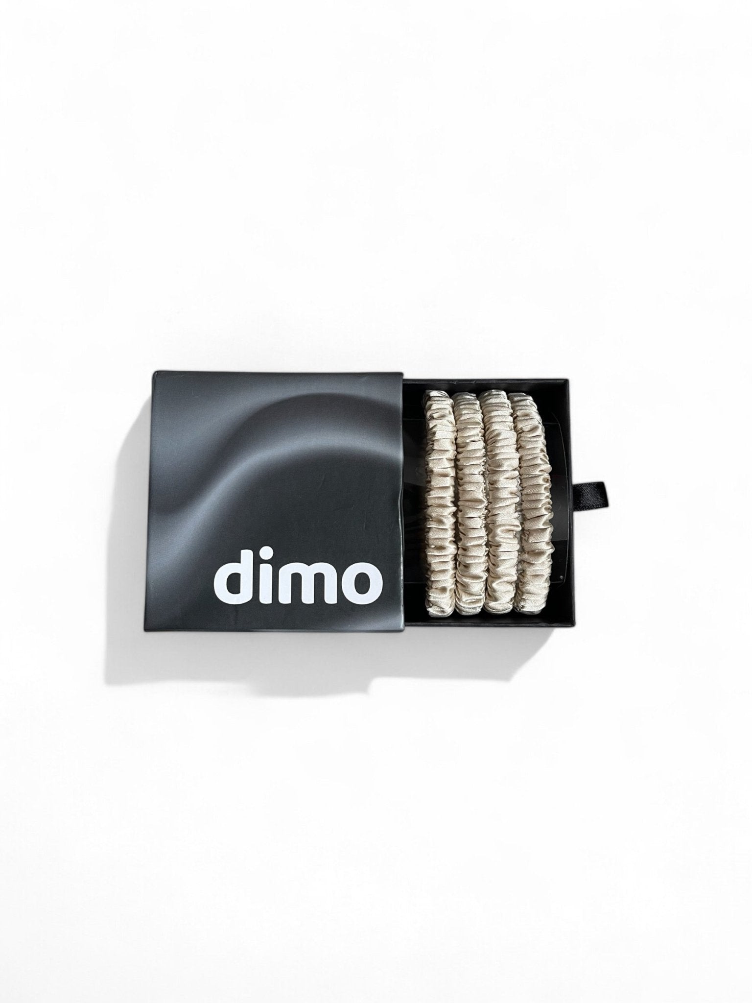 Set of golden silk skinny hair ties made from 100% mulberry silk, designed to prevent hair breakage and reduce frizz while adding elegance to your hairstyle. dimo gift box