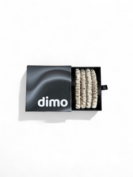 Set of golden silk skinny hair ties made from 100% mulberry silk, designed to prevent hair breakage and reduce frizz while adding elegance to your hairstyle. dimo gift box