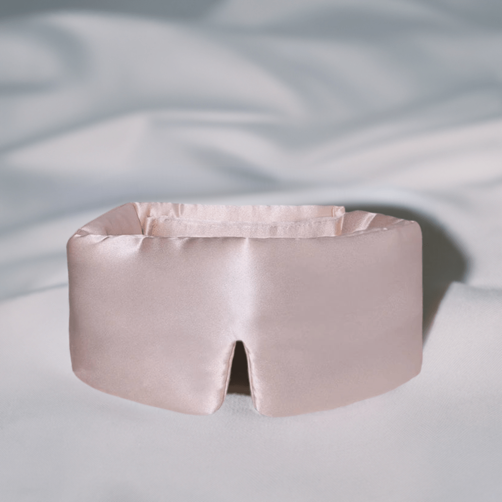 Premium blackout silk sleep mask in blush, made with 100% mulberry silk for a luxurious and restful sleep experience.